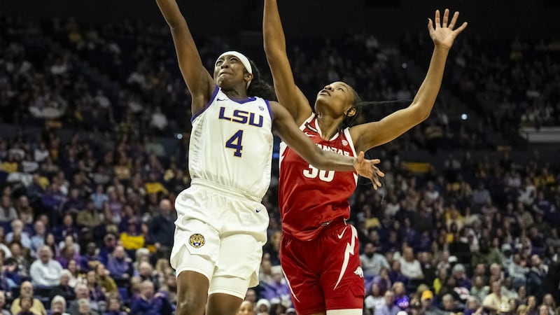LSU guard Flau'jae Johnson (4) attempts a layup against Arkansas forward Maryam Dauda (30) in...