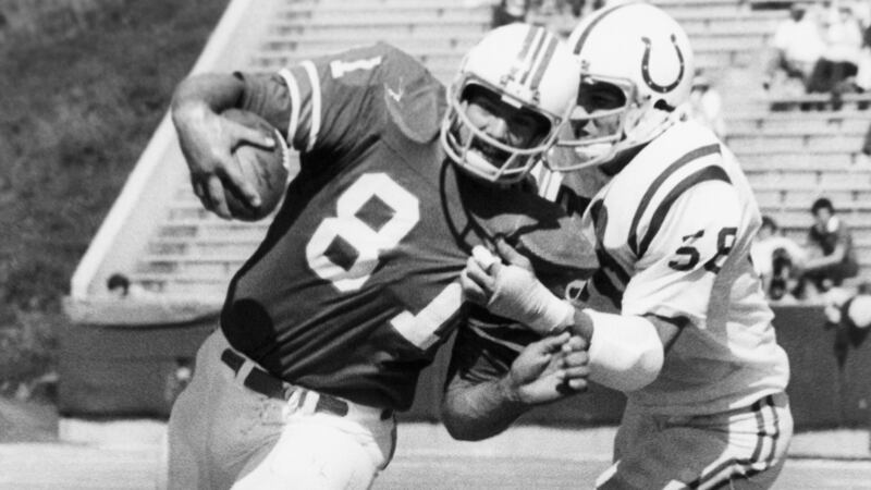 FILE - Russ Francis charges ahead four yards for the Patriots as the Colts' Derrel Luce has a...