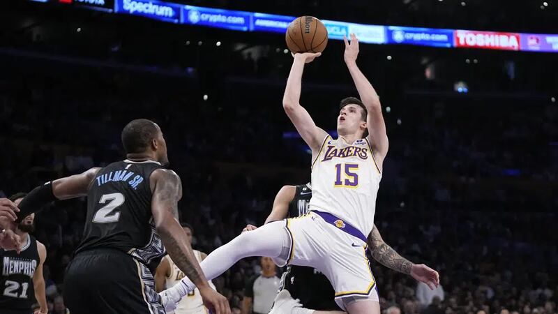 Los Angeles Lakers guard Austin Reaves, right, shoots as Memphis Grizzlies forward Xavier...