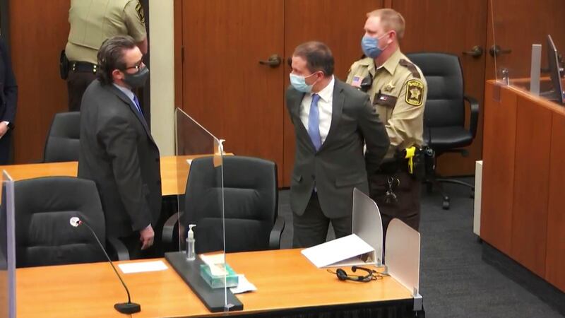 FILE - Former Minneapolis Police Officer Derek Chauvin, center, is taken into custody as his...
