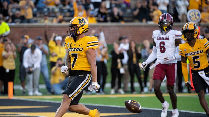Missouri running back Cody Schrader, left, drops the ball after scoring a touchdown during the...