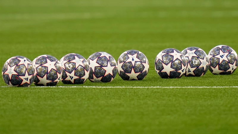 Soccer balls sit on the pitch ahead of the Champions League final soccer match between...