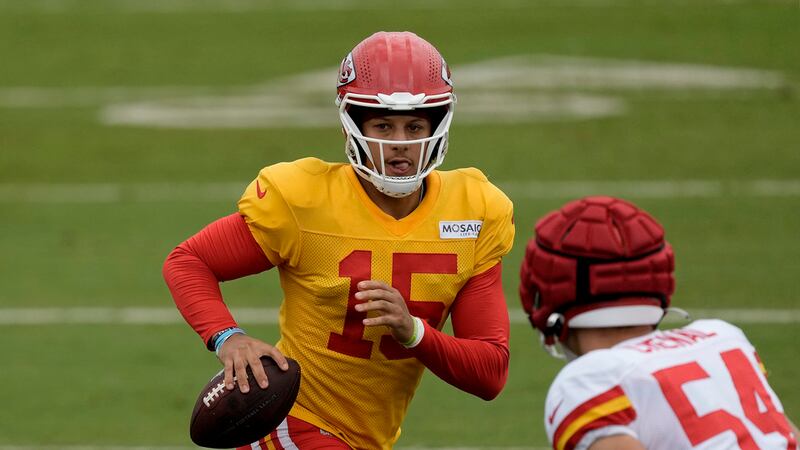 Kansas City Chiefs quarterback Patrick Mahomes looks to pass under pressure from linebacker...