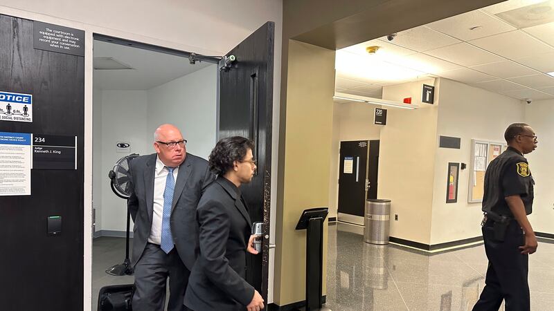 Al-Hassan Aiyash, center, leaves a court with his attorney Ben Gonek on Tuesday, June 6, 2023,...