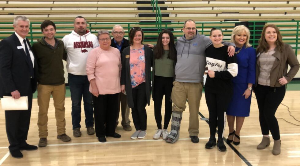 Amie Cole is surrounded by her family after a big surprise assembly held in her honor.