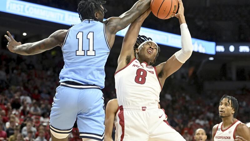 Arkansas forward Chandler Lawson (8) and Old Dominion forward Dani Pounds (11) fight for a...