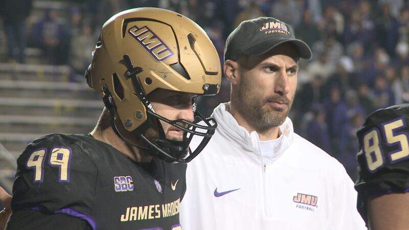 James Madison defensive lineman James Carpenter, left, and defensive line coach Pat Kuntz...