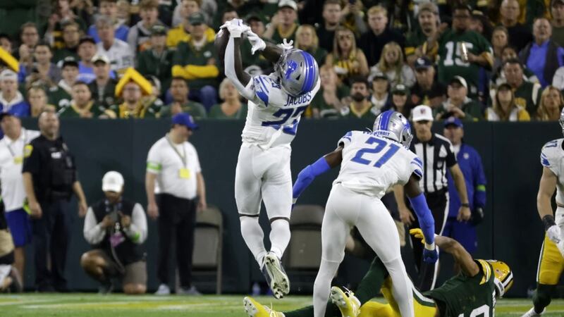 Detroit Lions cornerback Jerry Jacobs intercepts a pass during the first half of a NFL game on...