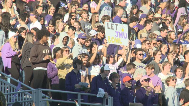 A James Madison fan holds up a sign, "Let them bowl," during a football game against UConn on...