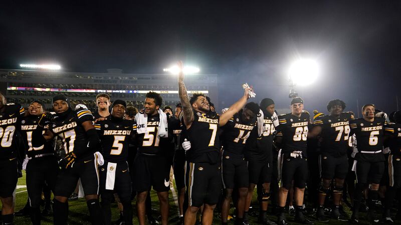 Missouri running back Cody Schrader (7) celebrates with teammates following an NCAA college...