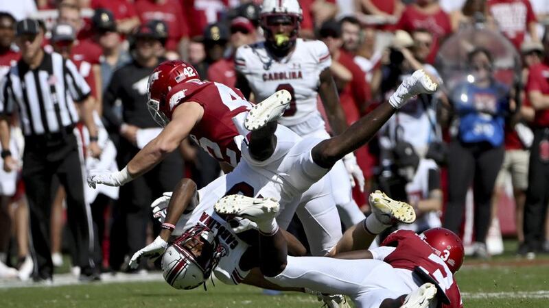 South Carolina receiver Jalen Brooks (13) is tackled by Arkansas defenders Drew Sanders (42)...