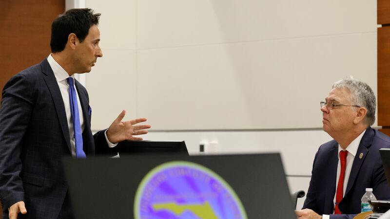 Defense attorney Mark Eiglarsh speaks with his client, former Marjory Stoneman Douglas High...