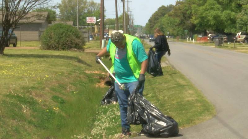 Nettleton High School students pick up litter near Allen Park for Earth Day.